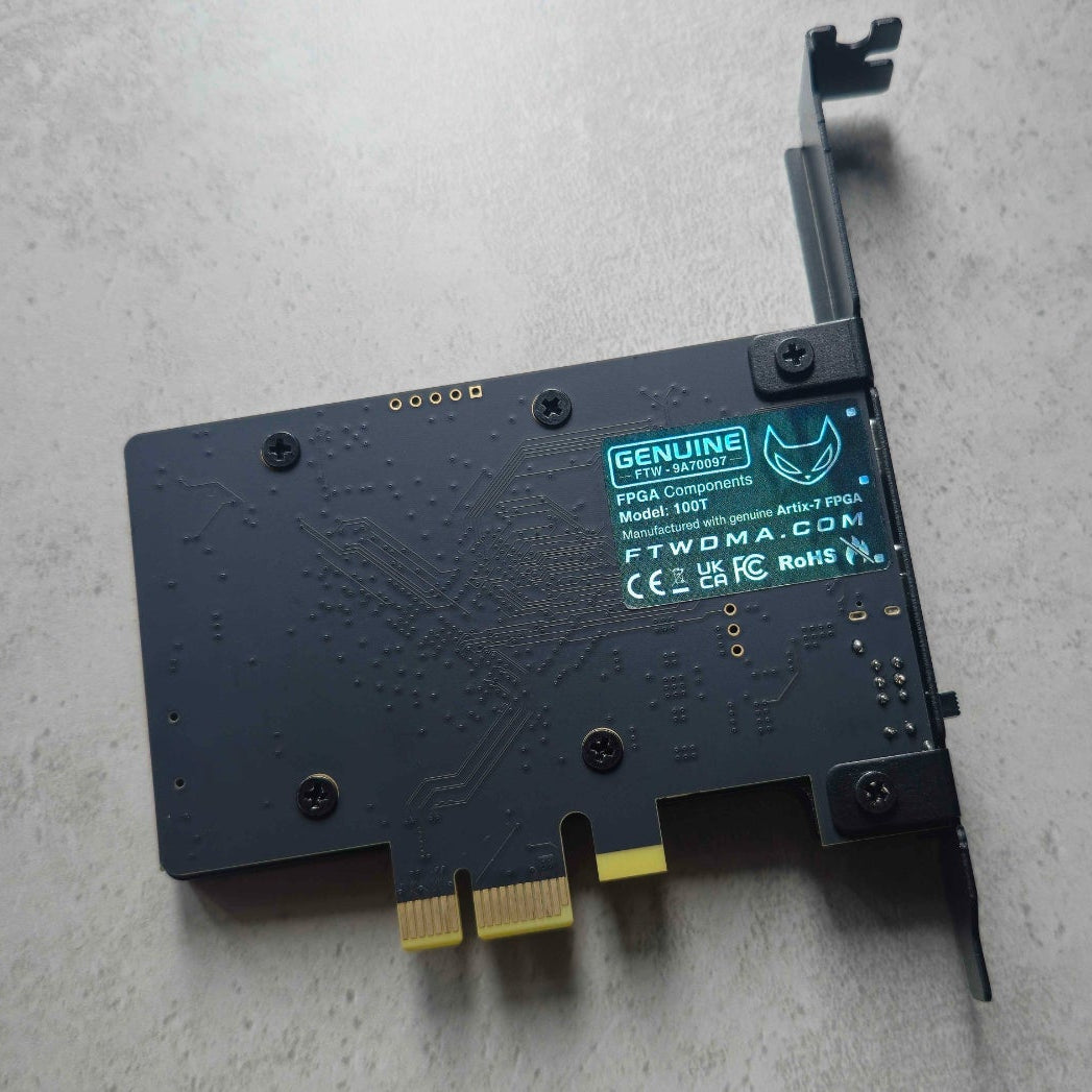 Back of the FTW DMA 100T Black Edition PCB with the genuine label: Model 100T, Artix-7 FPGA, CE, UKCA, FCC and RoHS marks